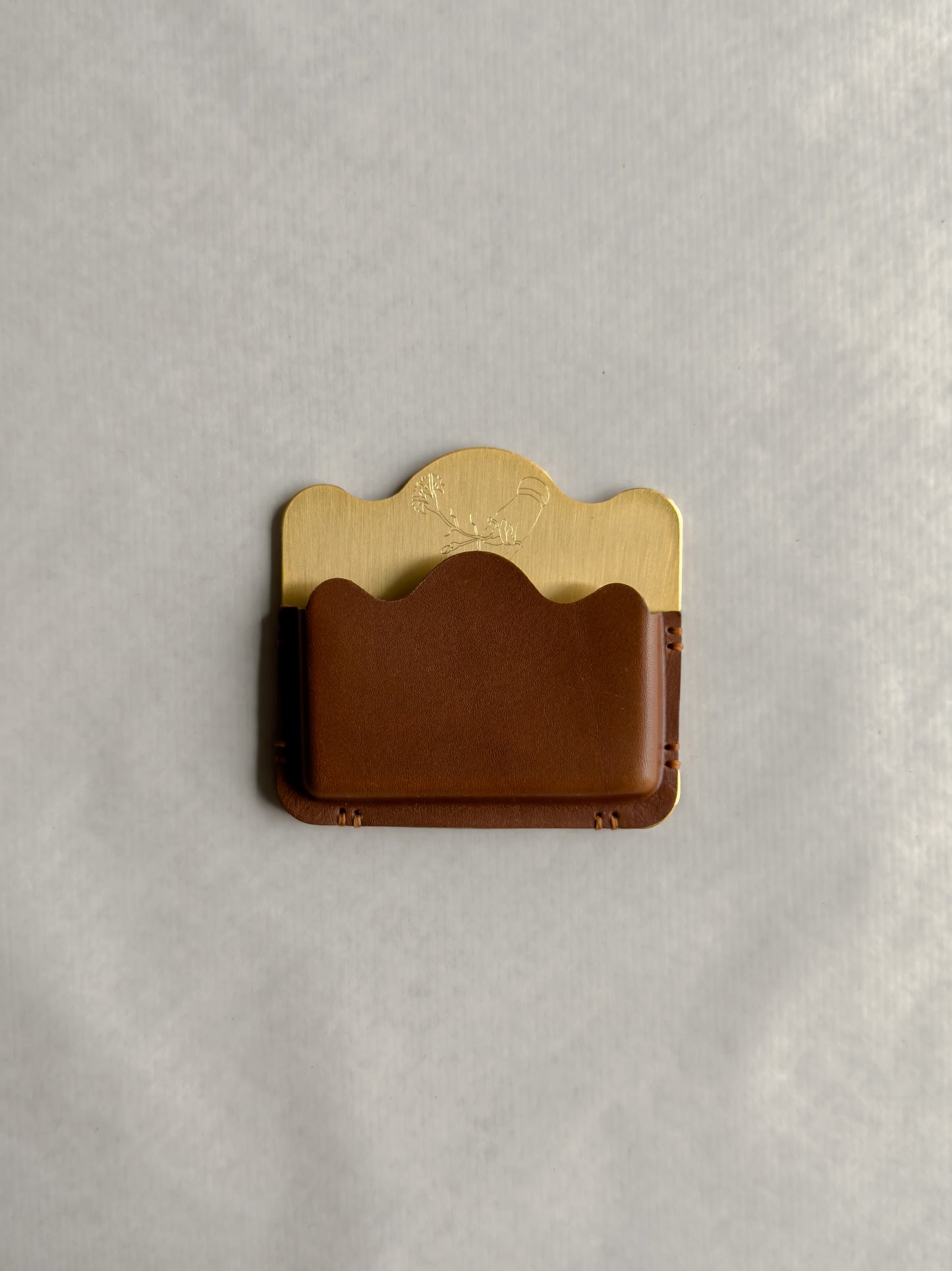 brass/brown card holder with Dâder Bânu's hand detail