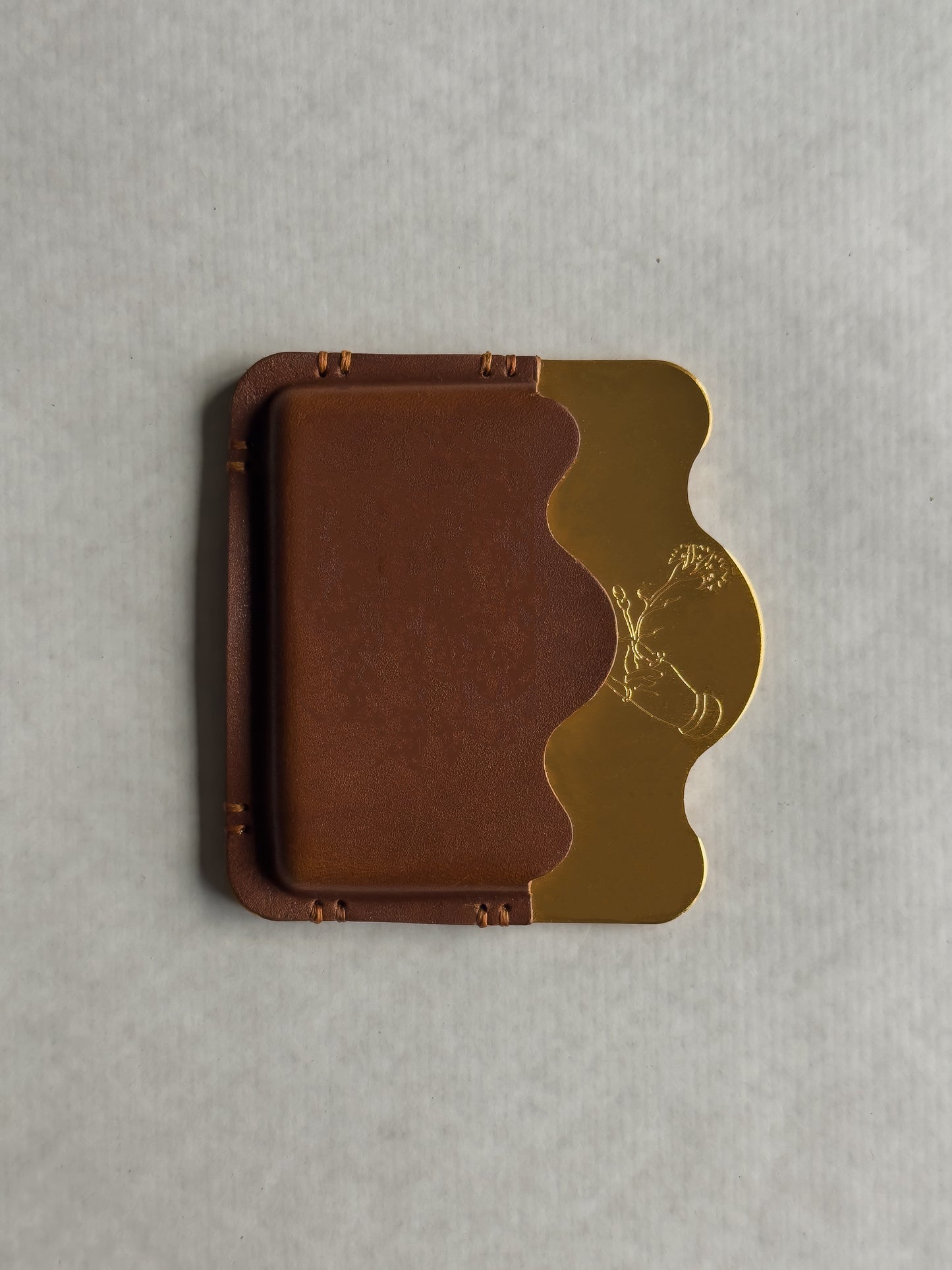 brass/brown card holder with Dâder Bânu's hand detail