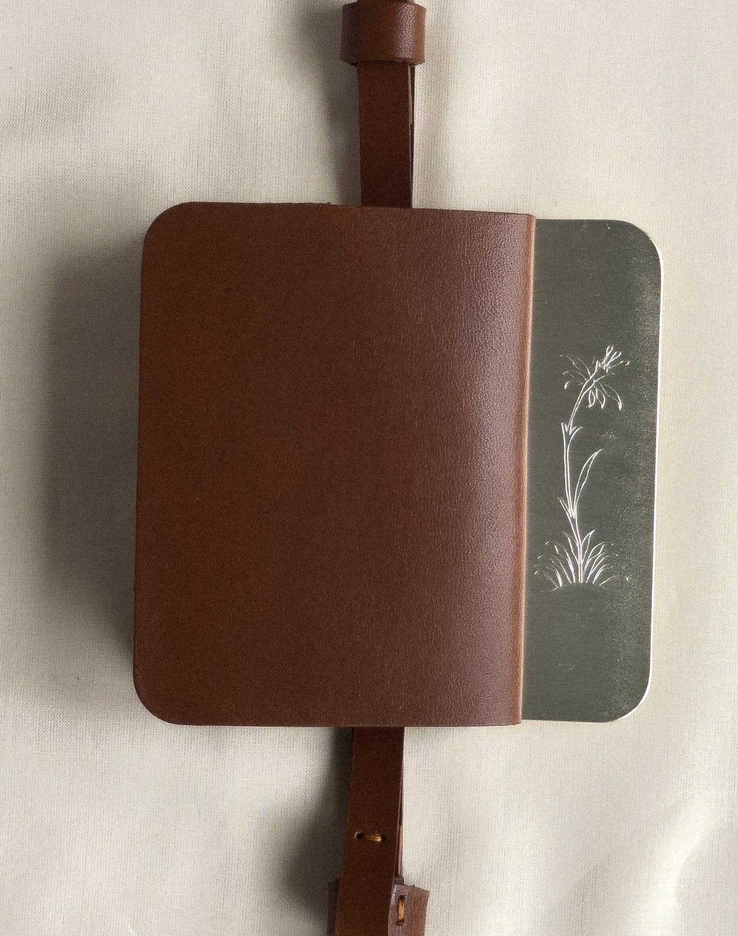 silver/brown flap belt bag with signature of Levnî