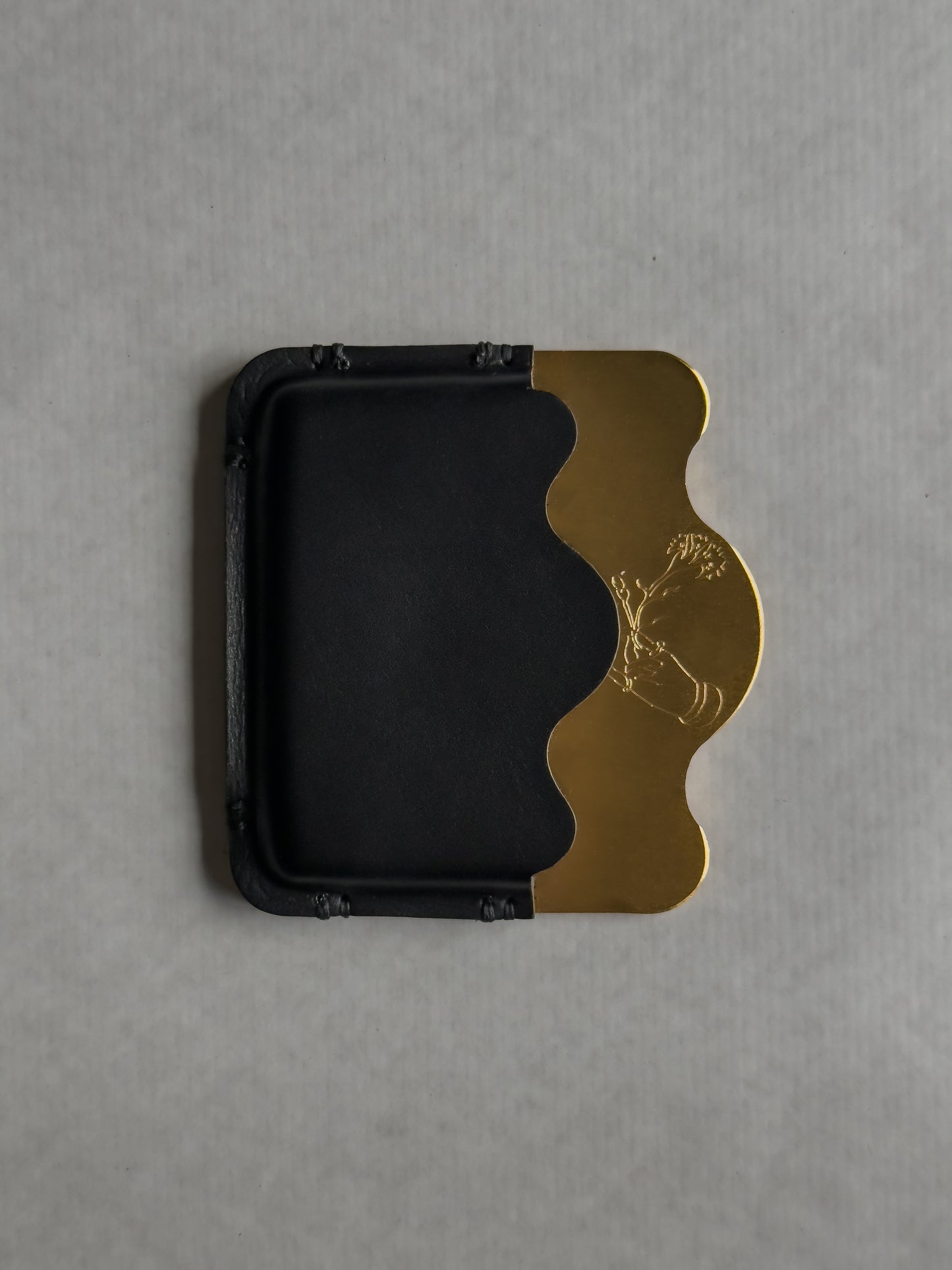 brass/black card holder with Dâder Bânu's hand detail