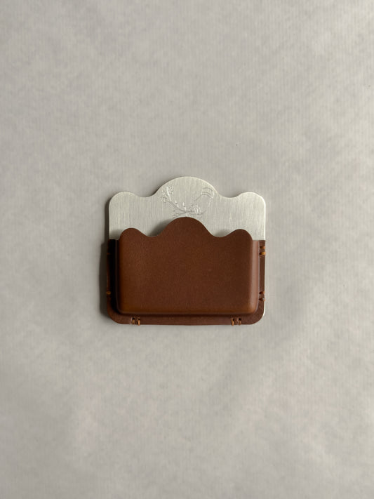 silver/brown card holder with Dâder Bânu's hand detail