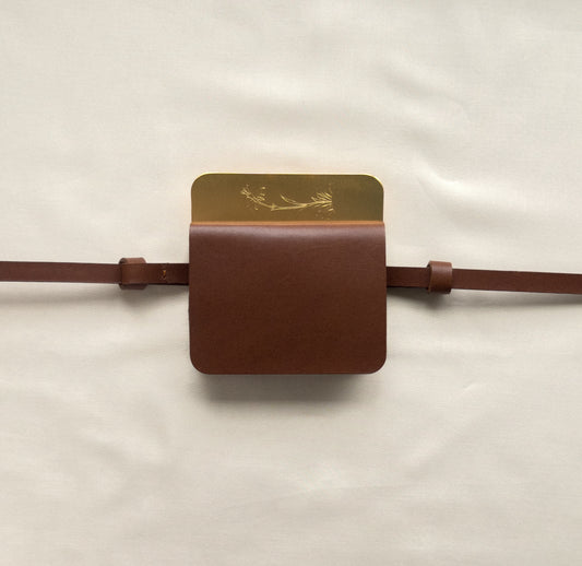 semi-treated brass/brown leather flap belt bag with signature of Levnî
